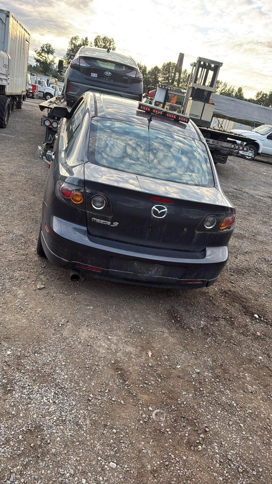 Dark sedan at a vehicle yard